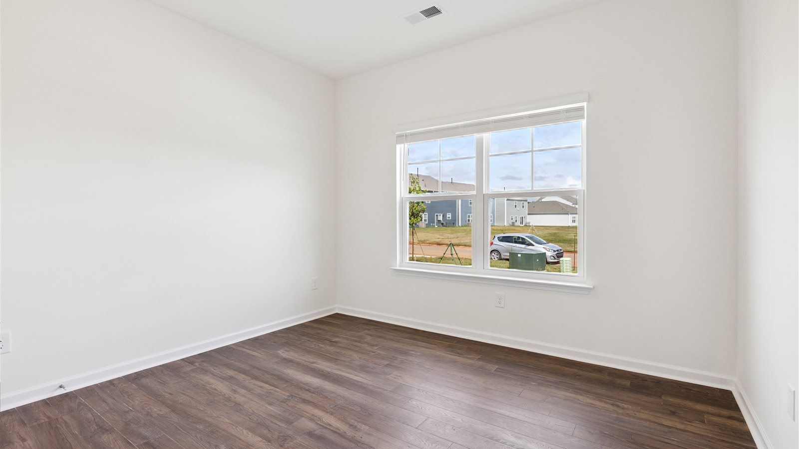 additional bedroom with vinyl floor and large window