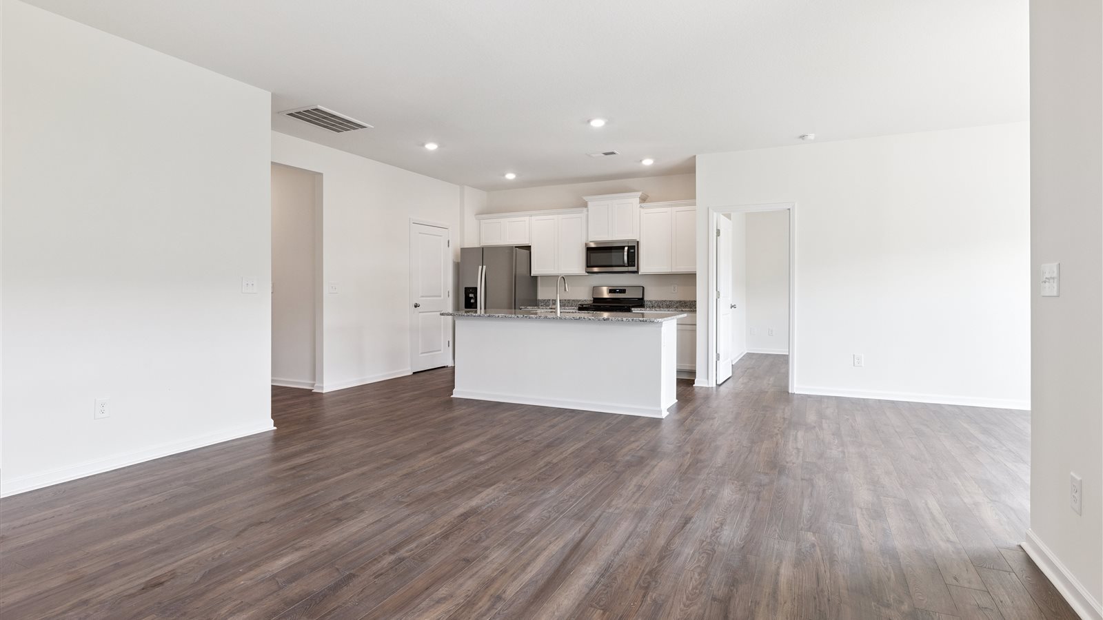 open concept living, dining, and kitchen area