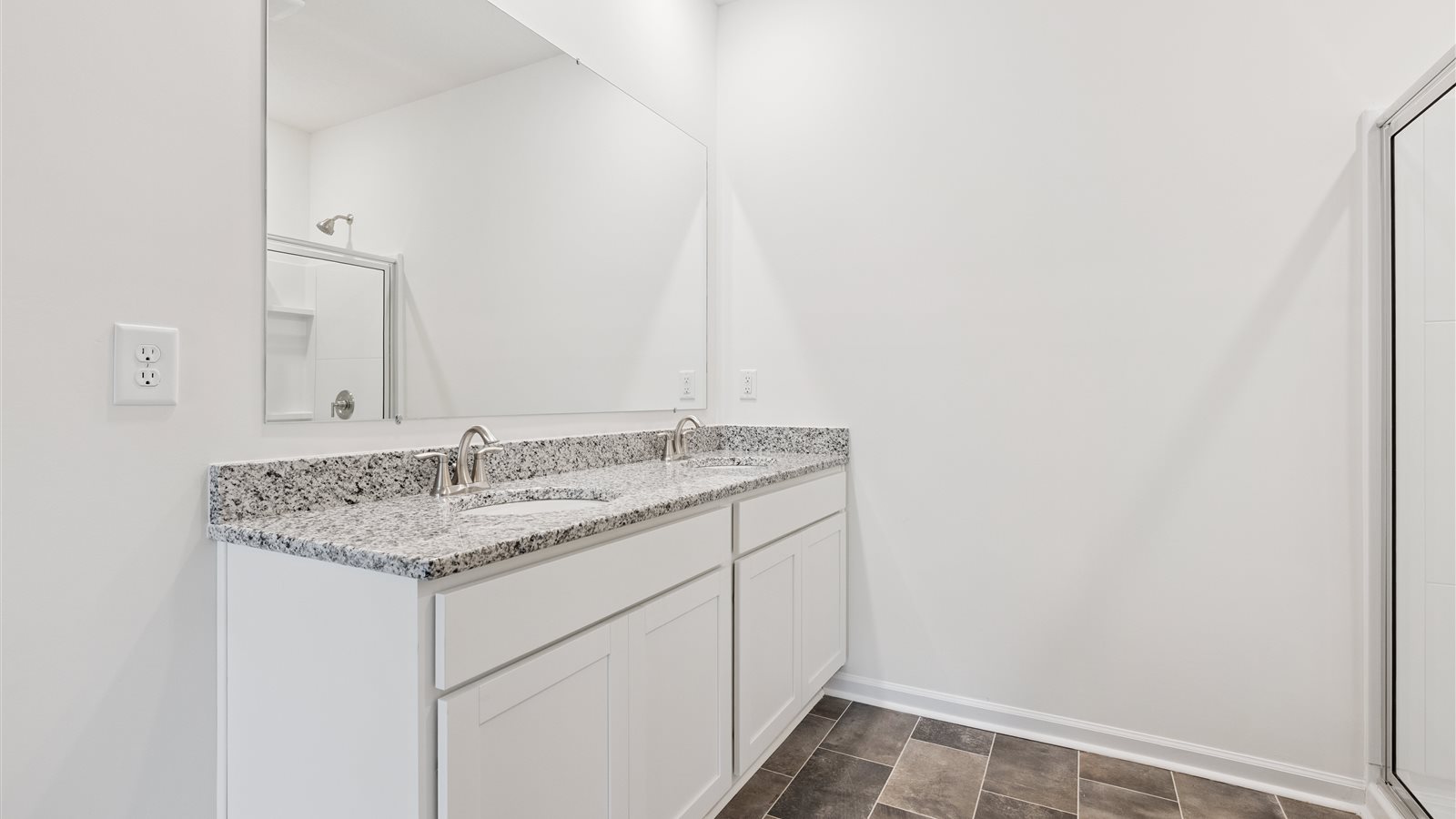Primary bathroom with double vanity and walk-in shower
