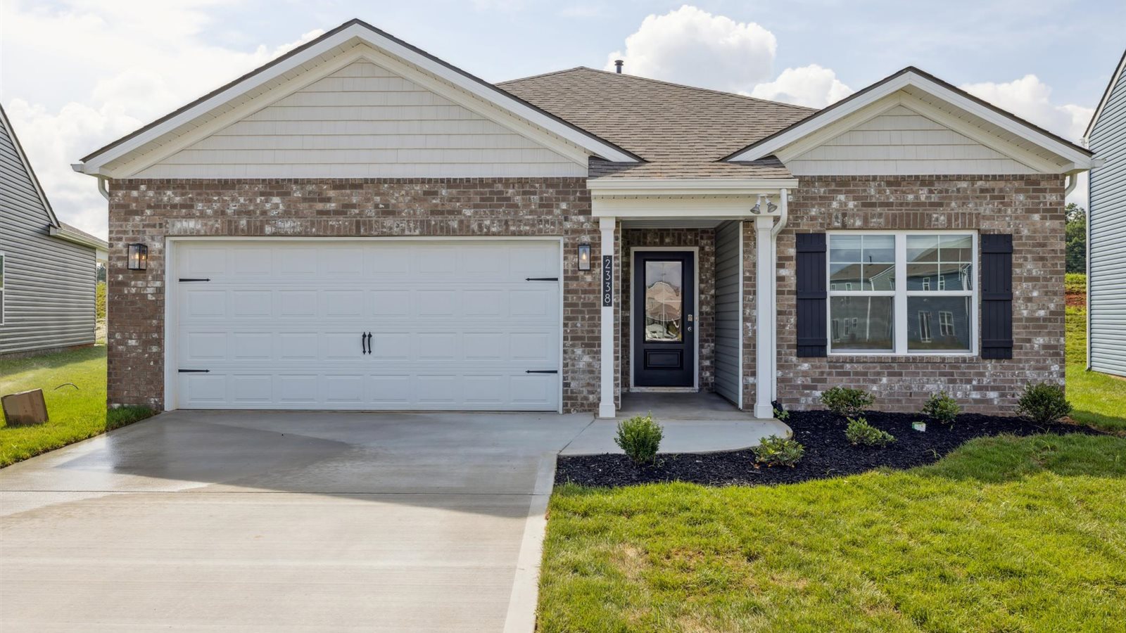 exterior of a single story home with vinyl and shake siding a brick accents