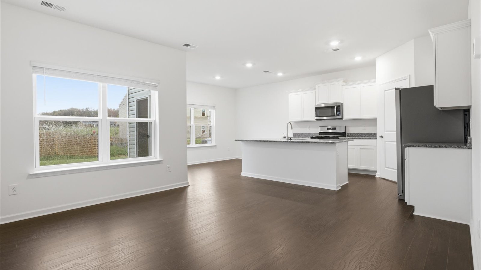 open concept main level of home with living area kitchen and dining noo