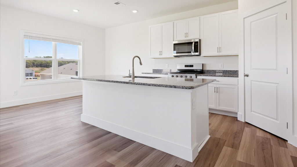 Kitchen with stainless steel appliances, shaker style cabinets, and elevated finishes
