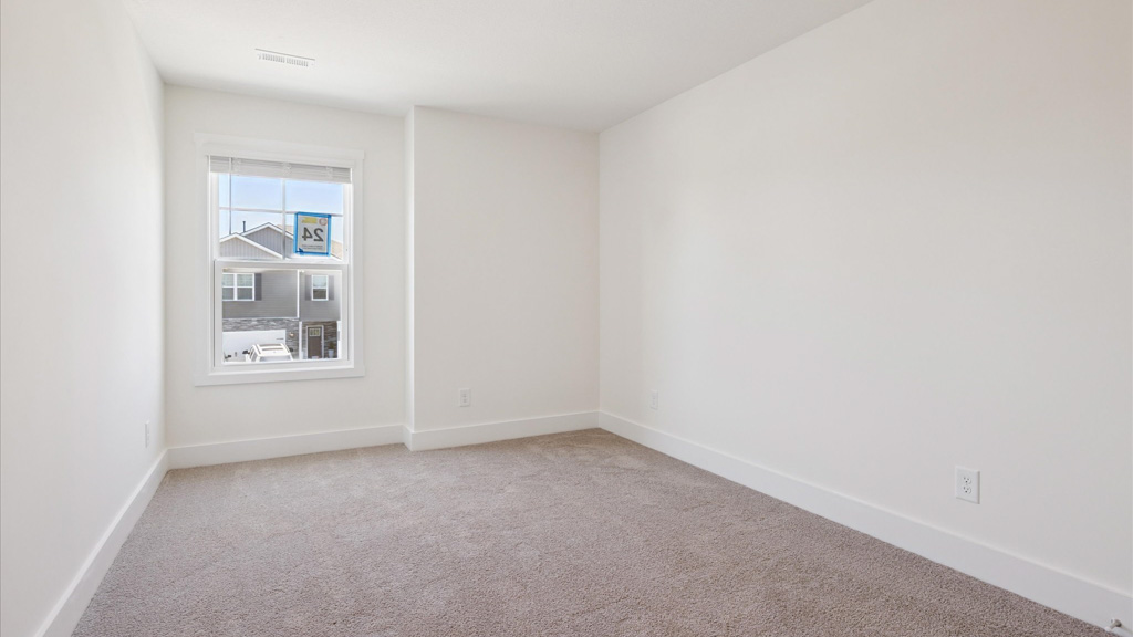 Bedroom with ample natural light and plush carpet floors