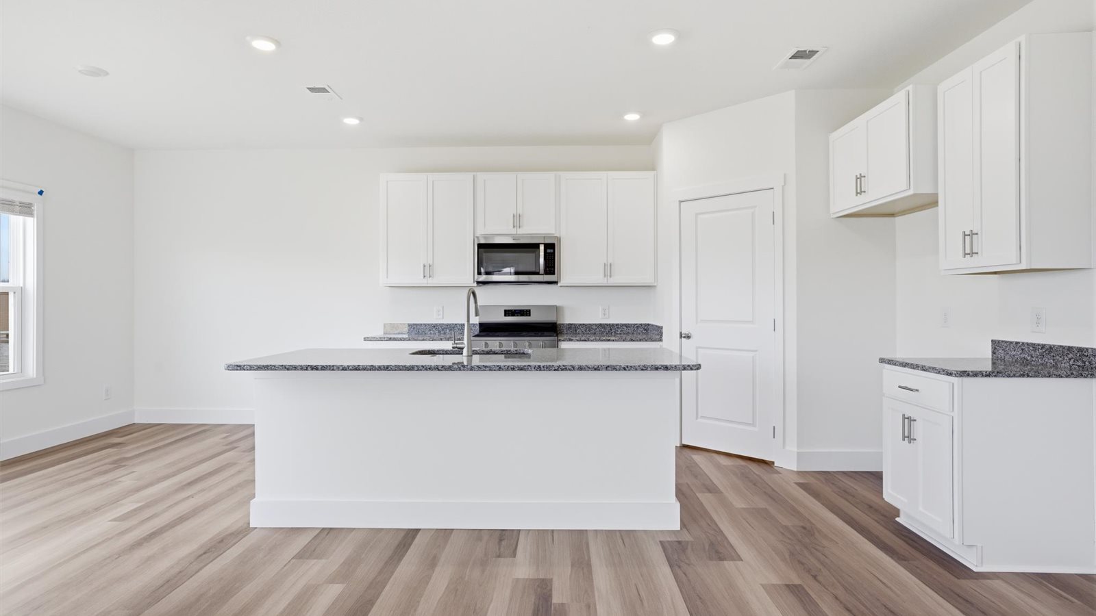 Open concept living, dining, and kitchen space