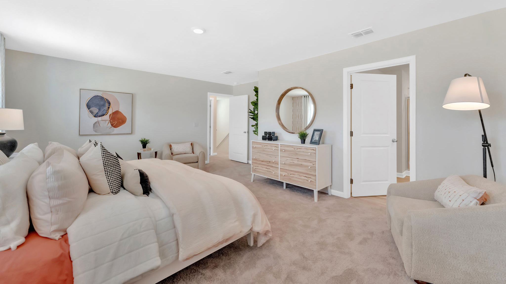 Primary bedroom with plush carpet floors and double light allowing windows