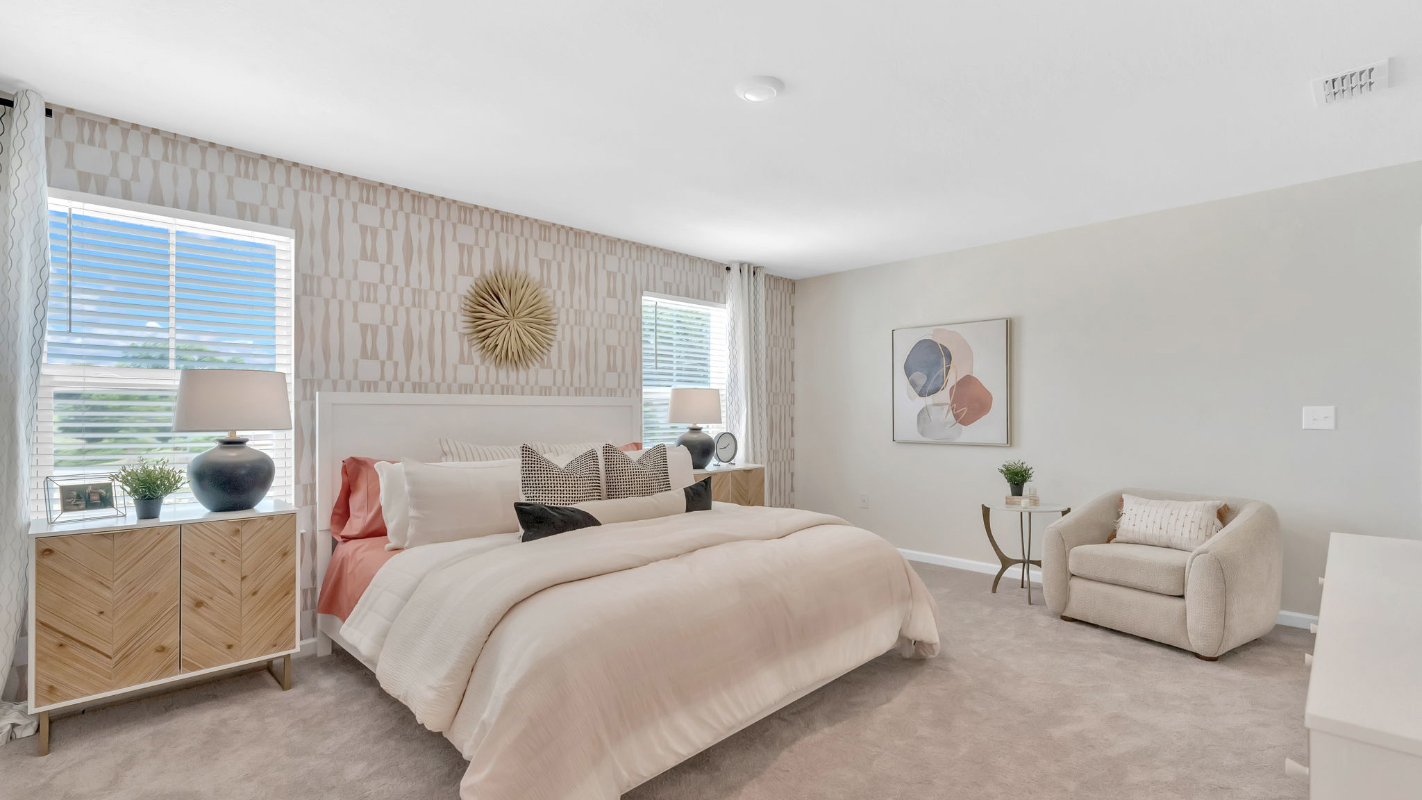 Primary bedroom with plush carpet floors and double light allowing windows