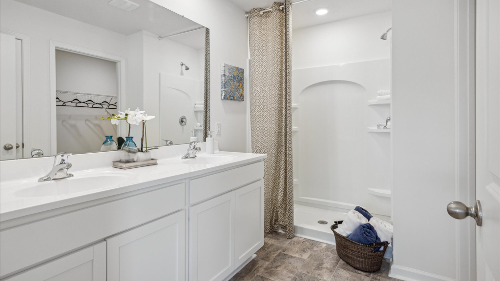 Primary bathroom with double vanity and walk-in shower