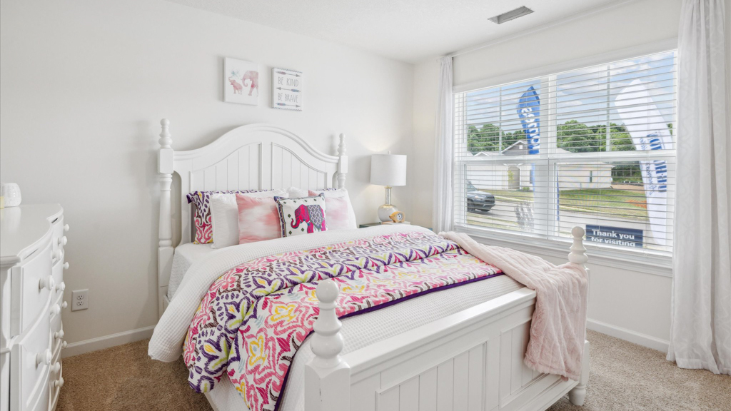 Bedroom with ample natural light and carpet floors