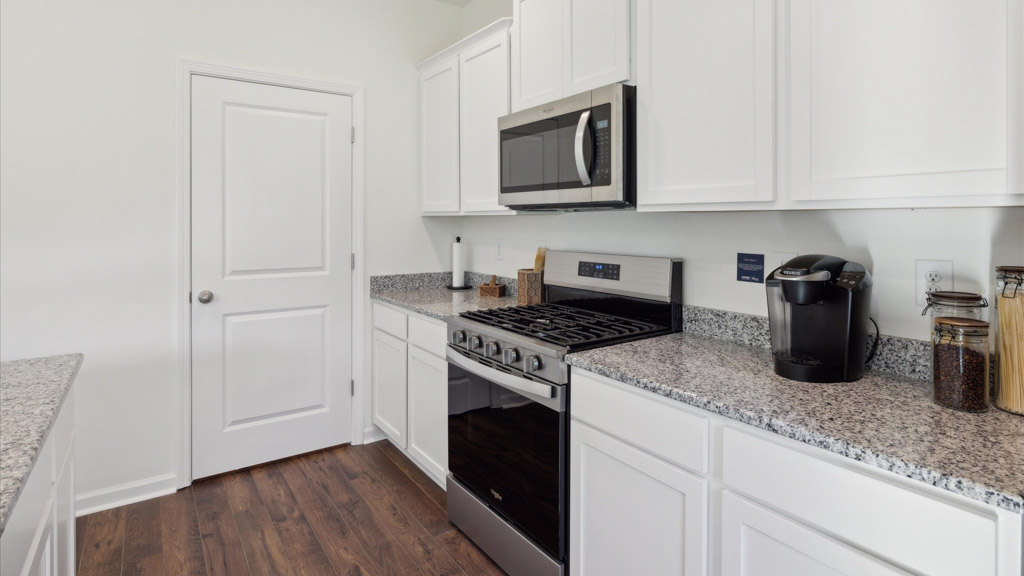 kitchen with stainless steel appliances, and shaker style cabinets