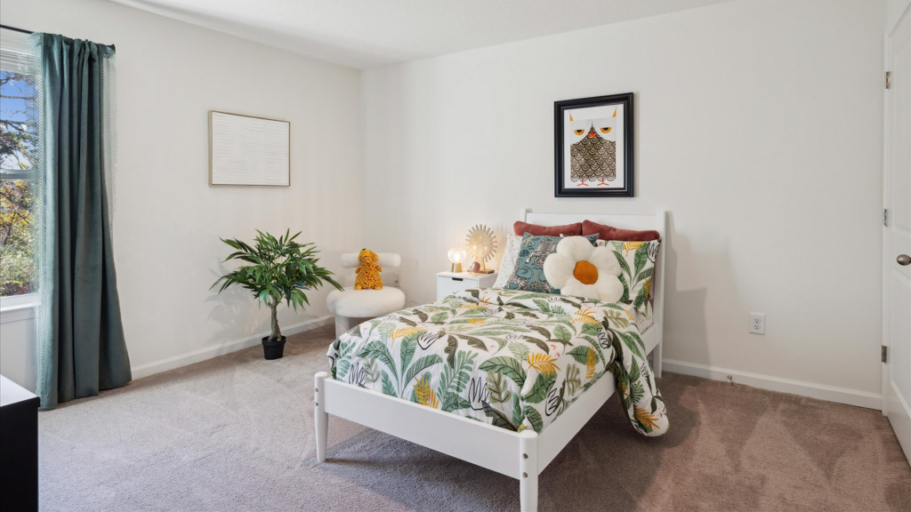 Bedroom with ample natural light and plush carpet floors