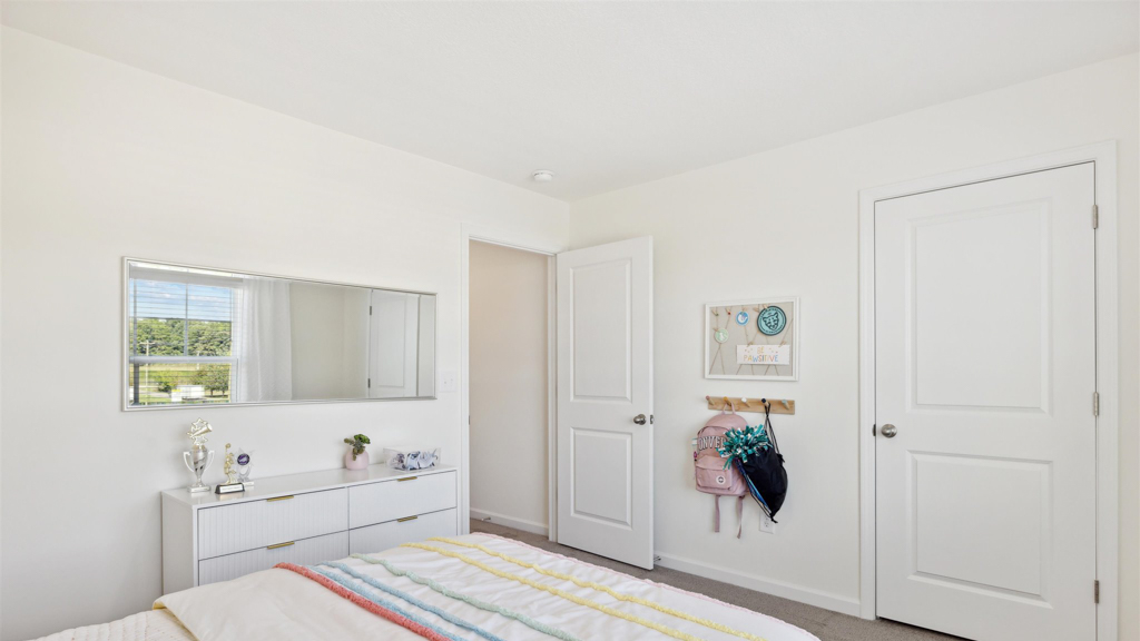 Bedroom with ample natural light and carpet floors