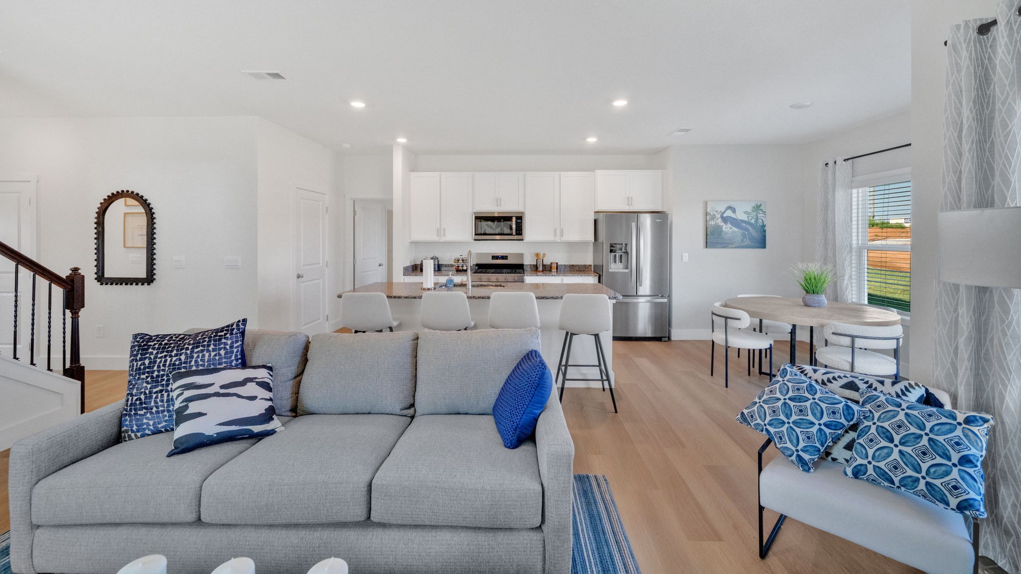 Spacious living and great  room space with light allowing windows