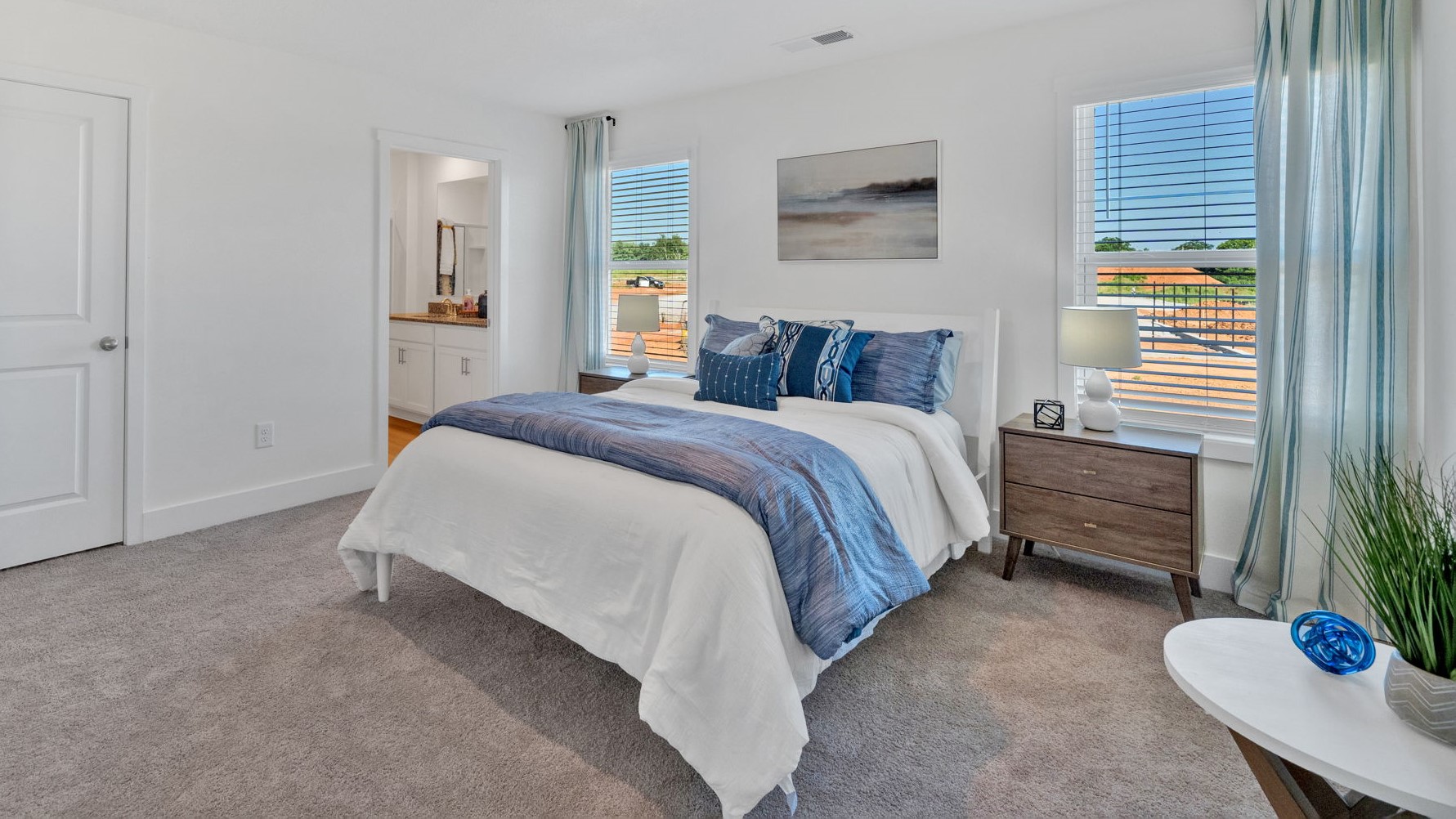 Primary bedroom with plush carpet floors and double light allowing windows