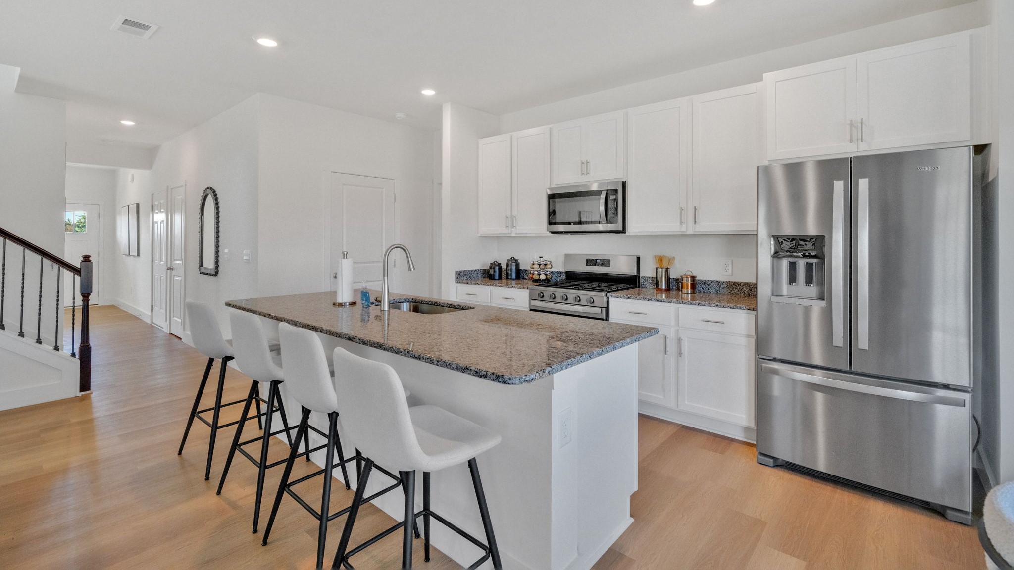 Open concept living, dining, and kitchen space