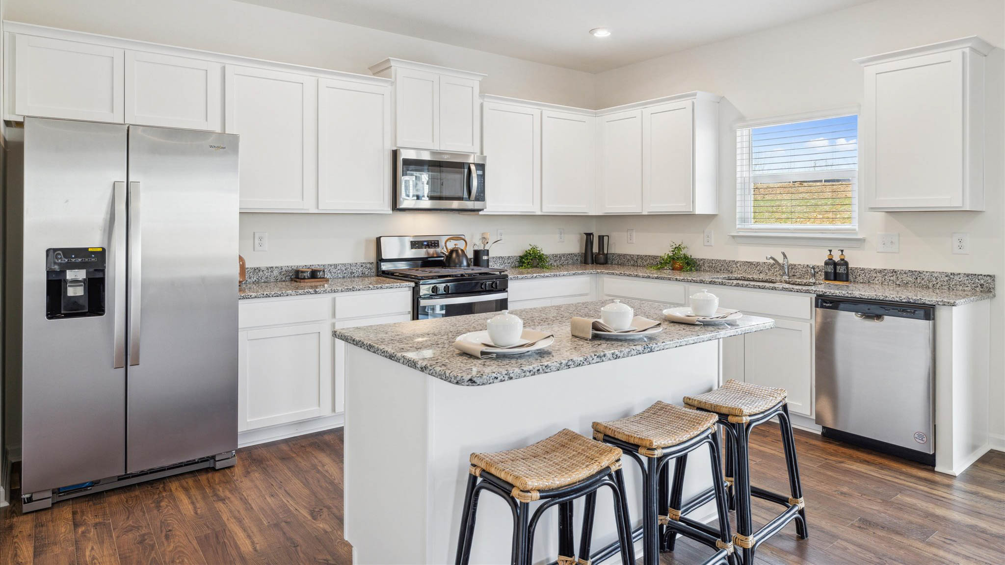 Kitchen with stainless steel appliances, shaker style cabinets, and elevated finishes