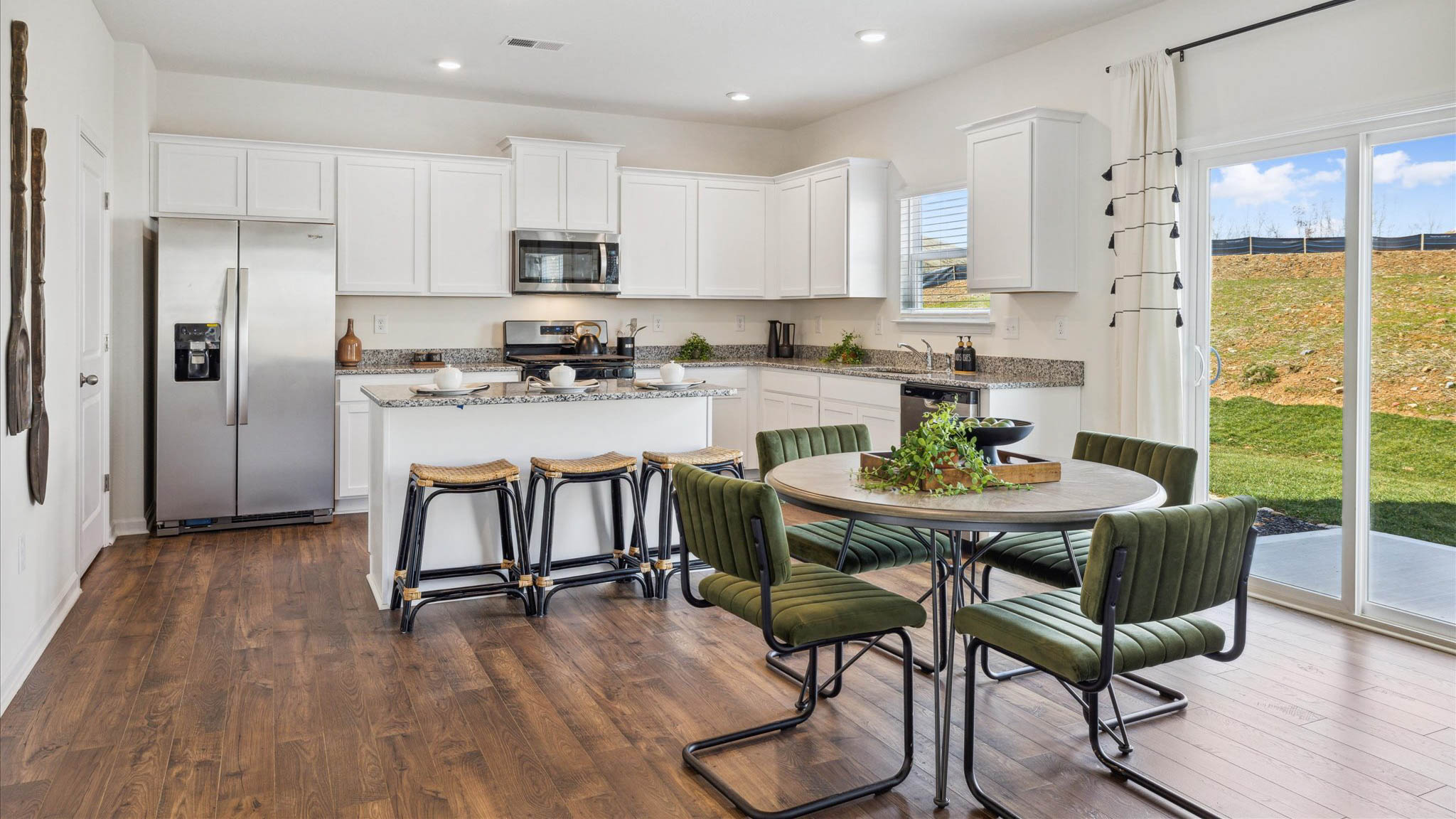 Open concept living, dining, and kitchen space