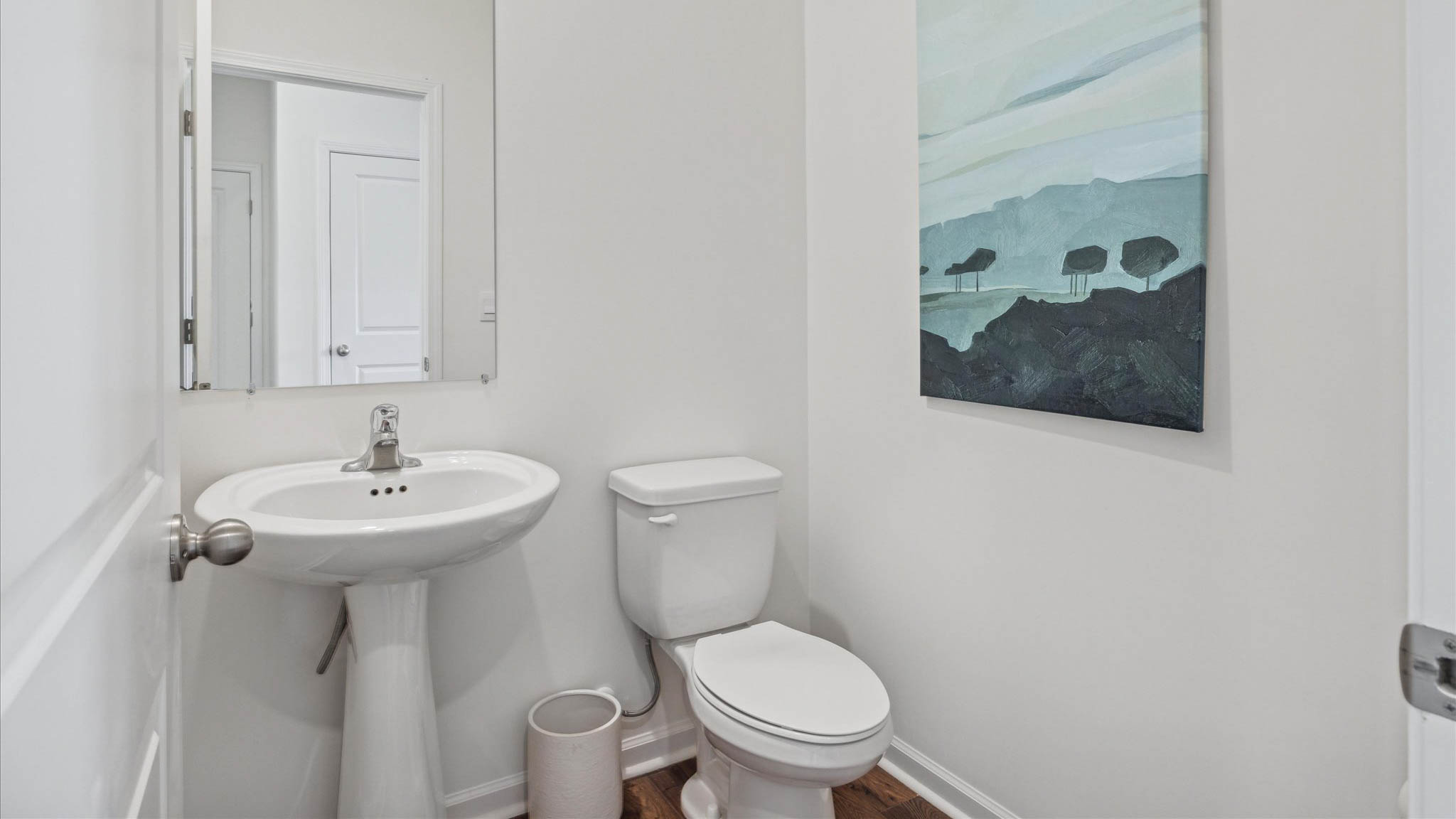 Downstairs guest half bathroom with pedestal sink