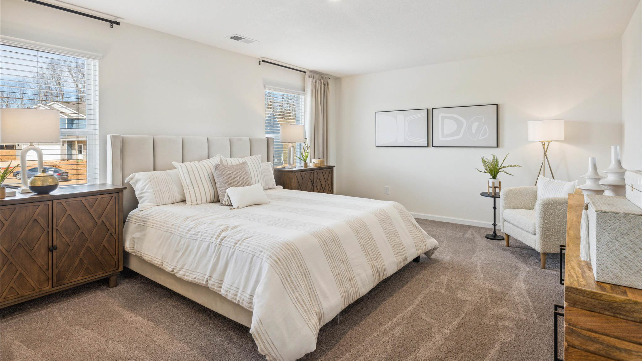 Primary bedroom with plush carpet floors and double light allowing windows