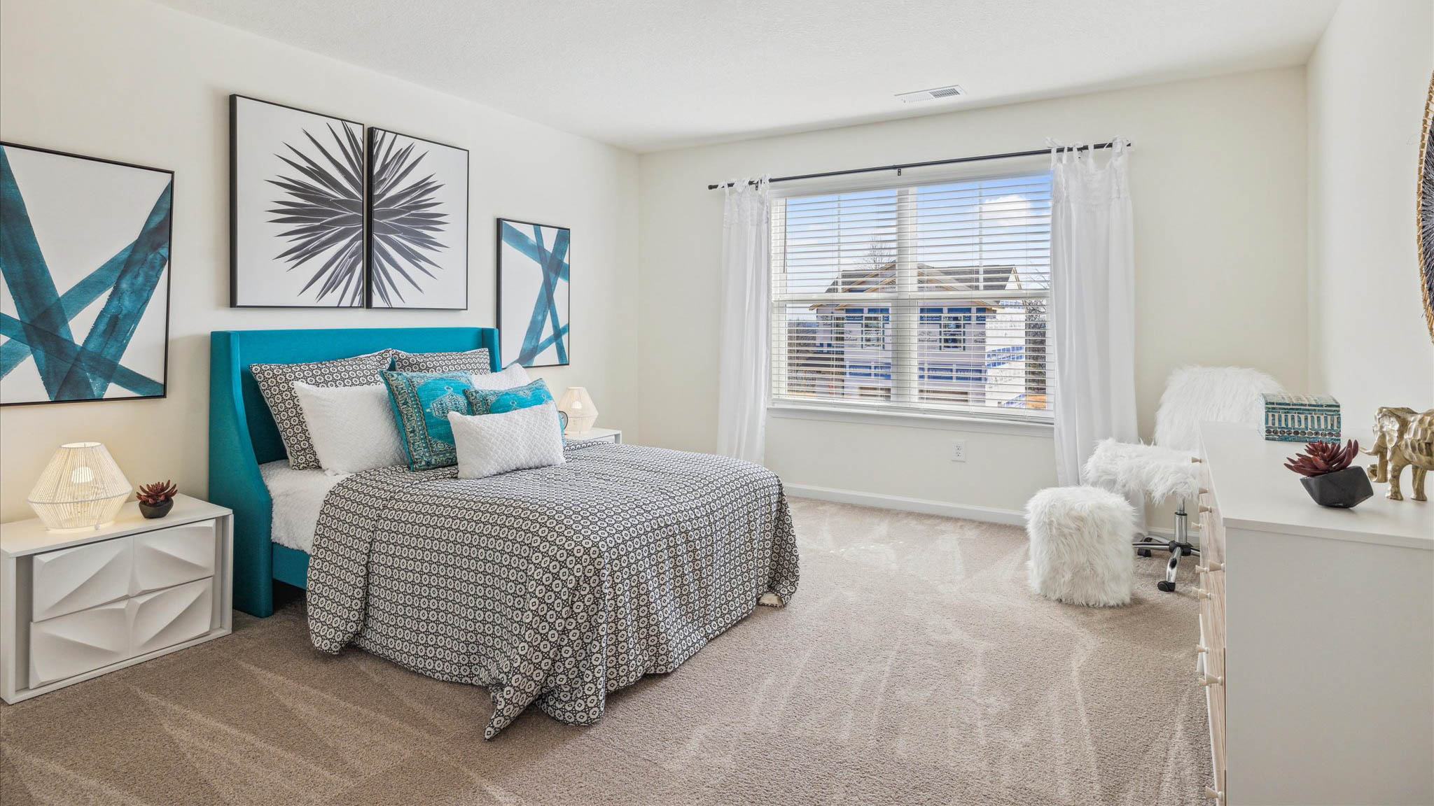 Bedroom with ample natural light and plush carpet floors