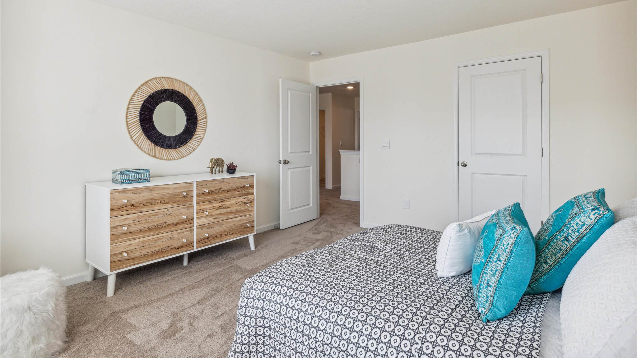 Bedroom with ample natural light and plush carpet floors
