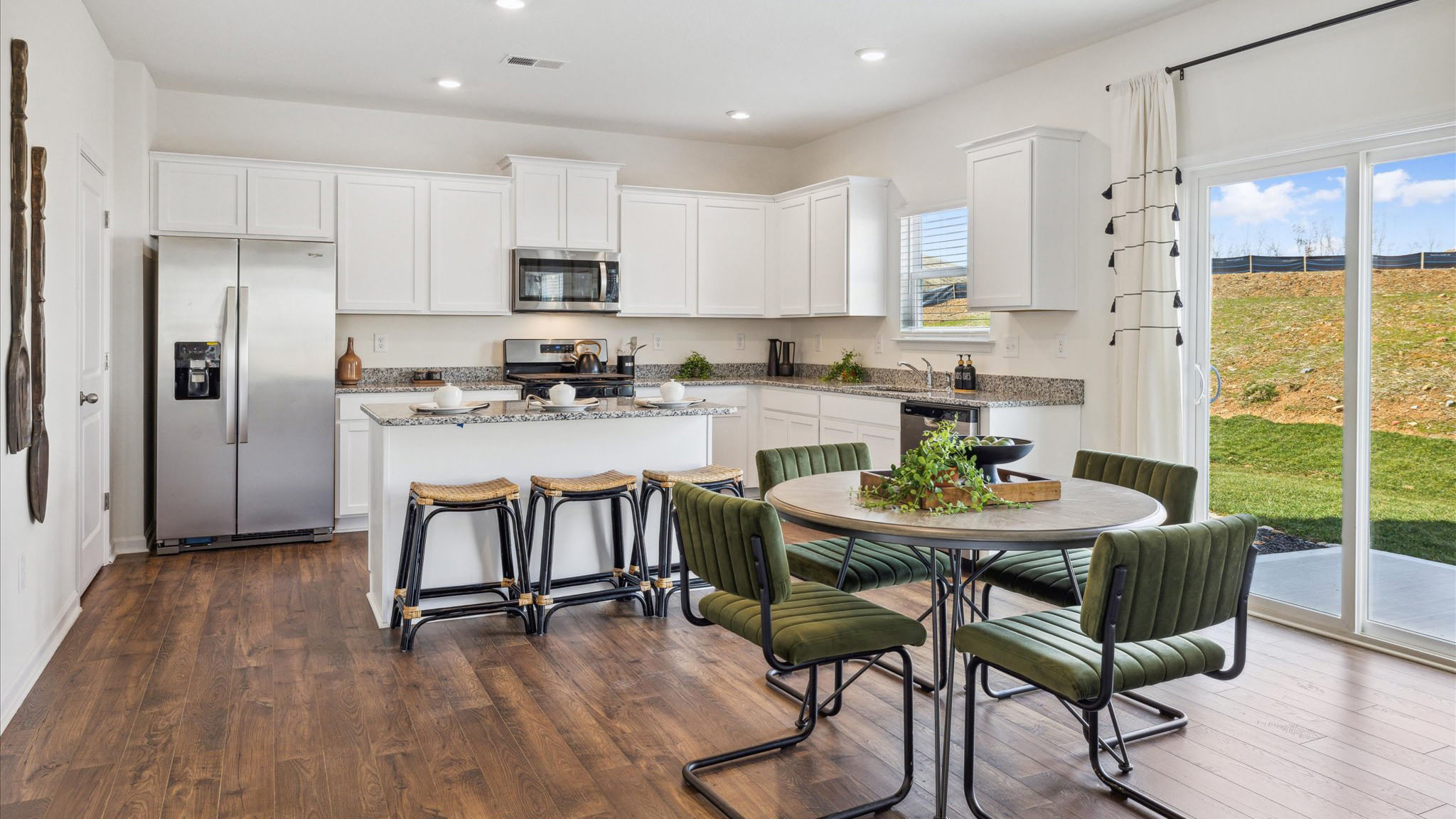 Open concept living, dining, and kitchen space