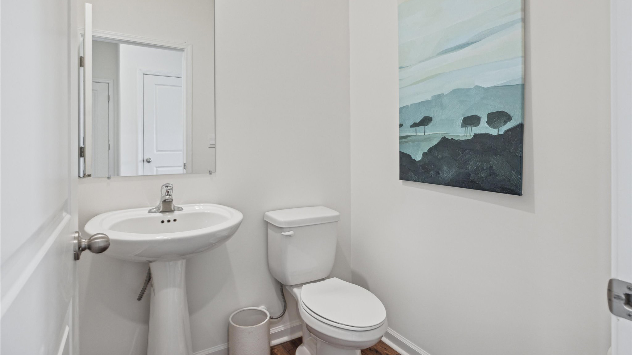 Downstairs guest half bathroom with pedestal sink