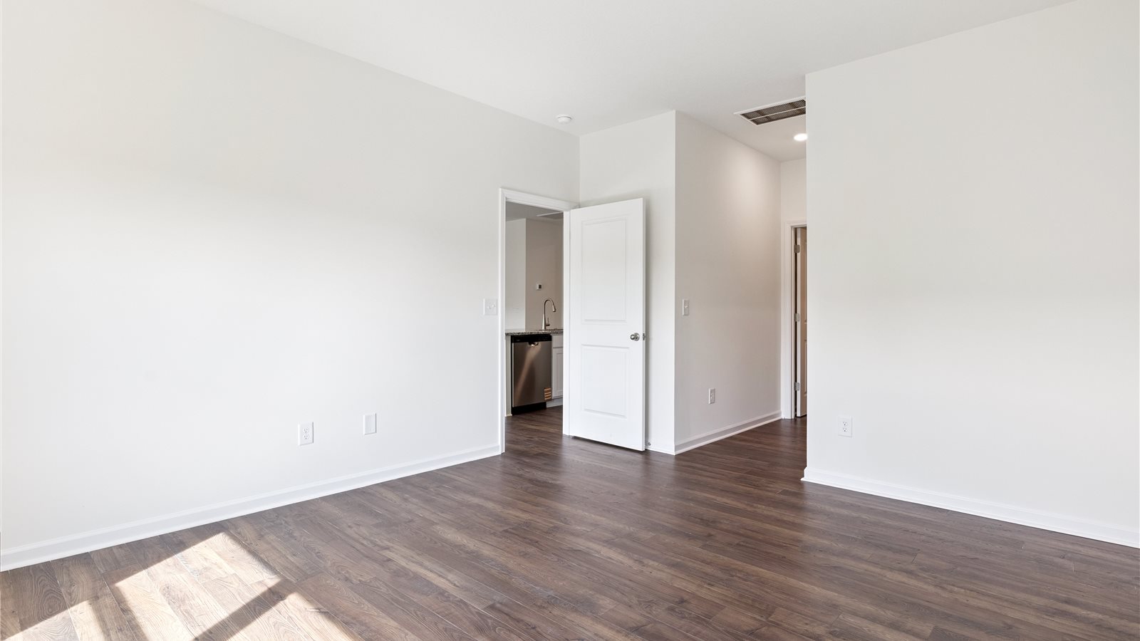 Primary bedroom with private attached bathroom and walk-in closet