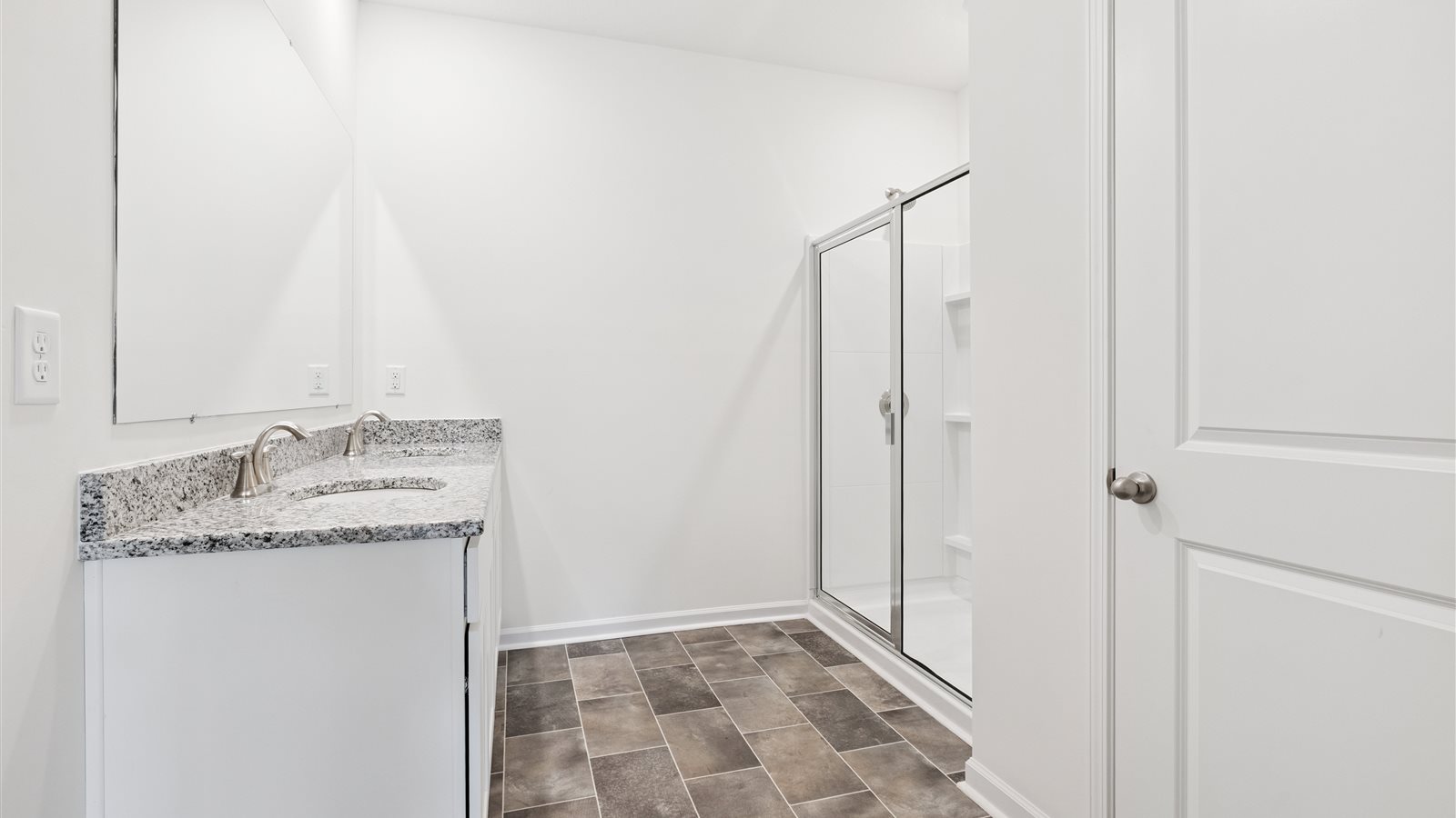 Primary bathroom with double vanity and walk-in shower