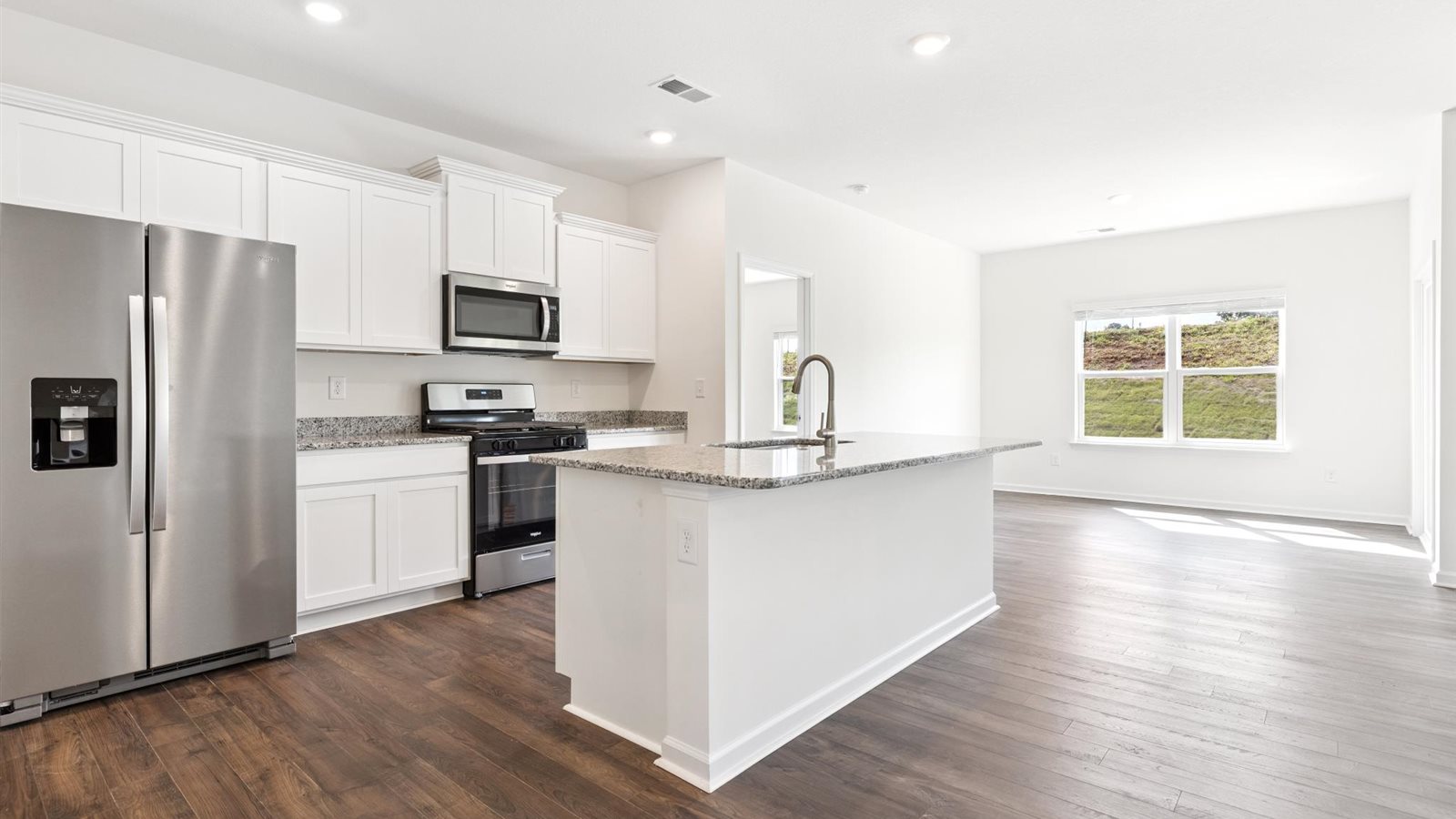 Open concept living, dining, and kitchen space