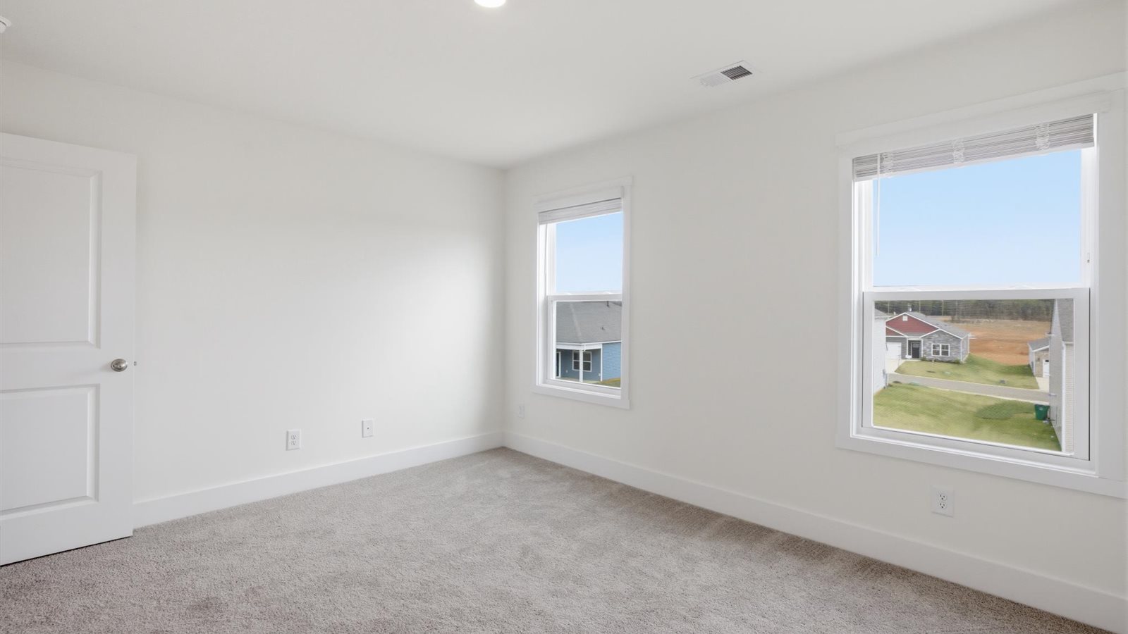 Primary bedroom with private attached bathroom and walk-in closet