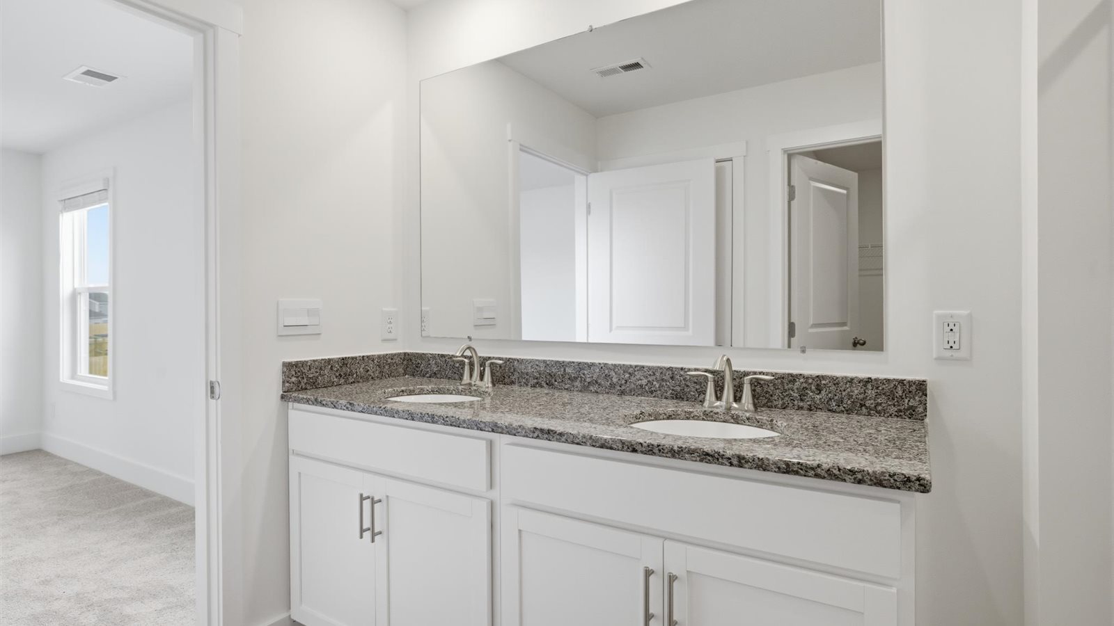 Primary bathroom with double vanity and walk-in shower