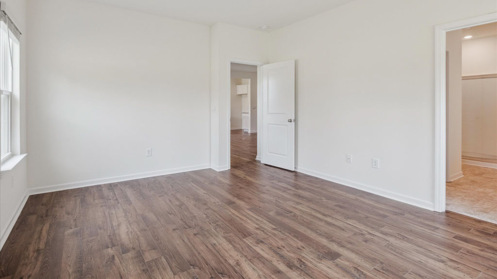 Primary bedroom with private attached bathroom and walk-in closet