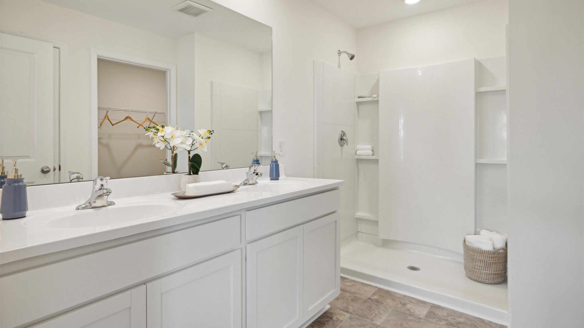 Primary bathroom with double vanity and walk-in shower