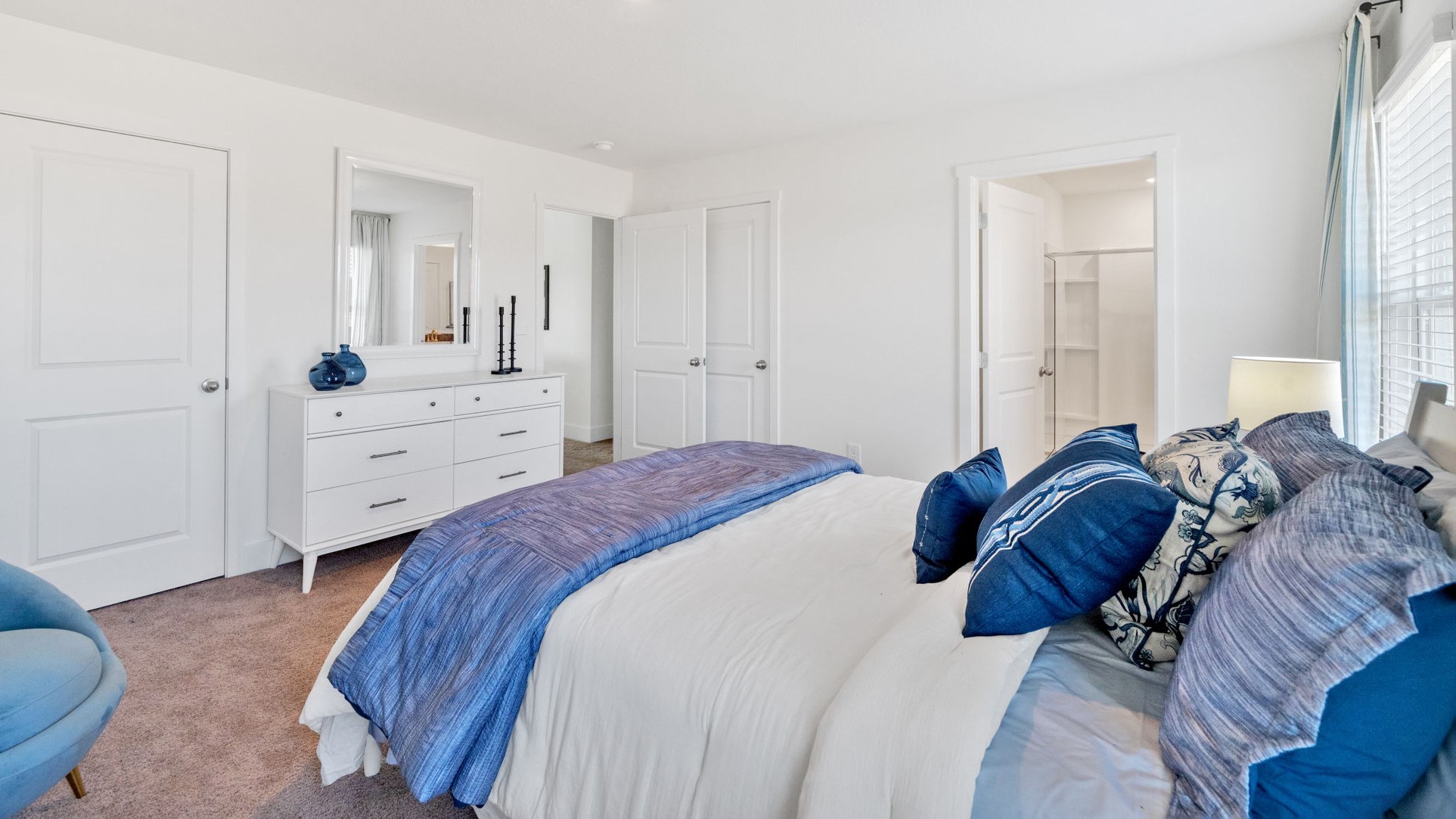 Primary bedroom with private attached bathroom and walk-in closet