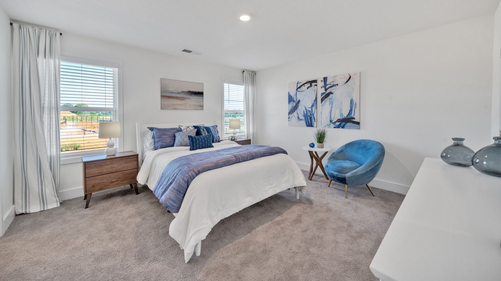 Primary bedroom with private attached bathroom and walk-in closet