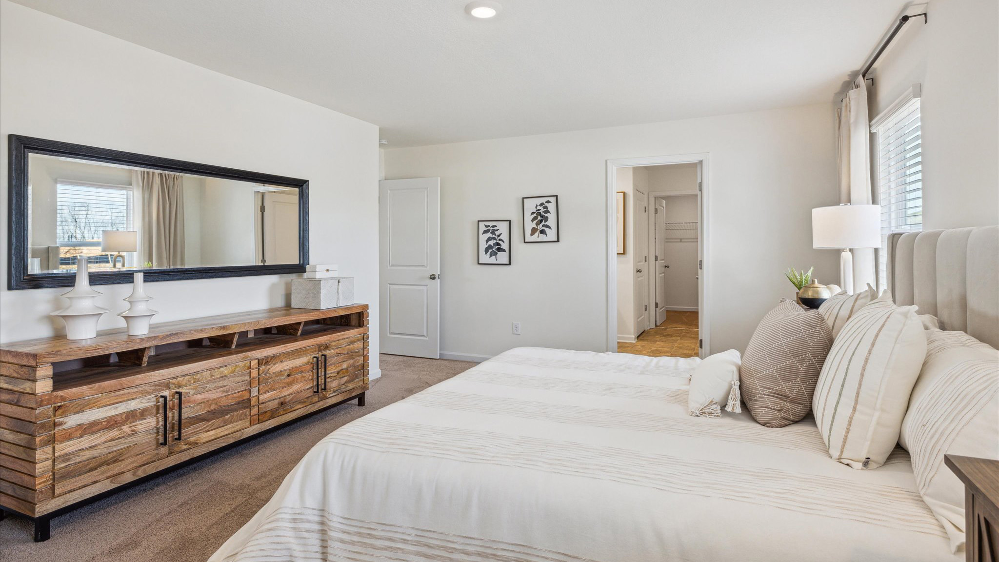 Primary bedroom with private attached bathroom and walk-in closet