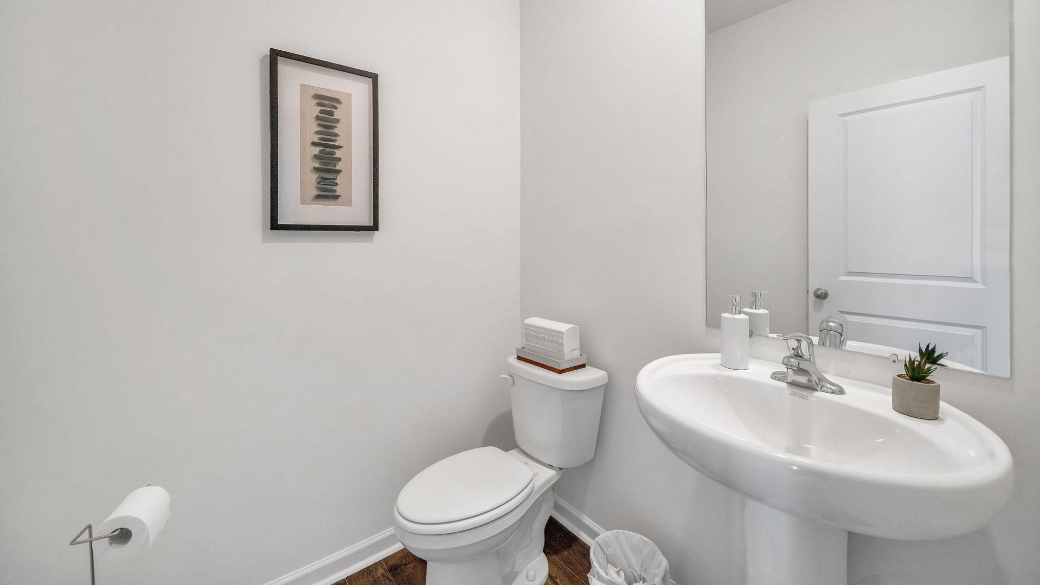 Downstairs guest half bathroom with pedestal sink