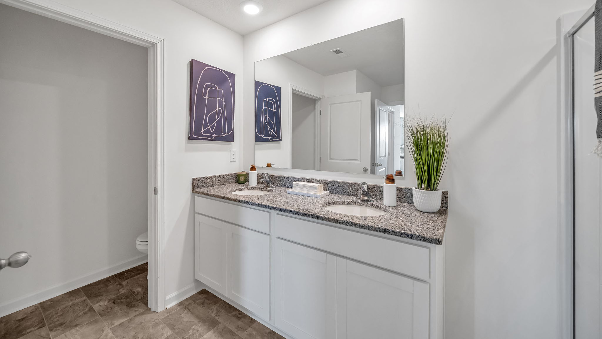 Primary bathroom with double vanity and walk-in shower