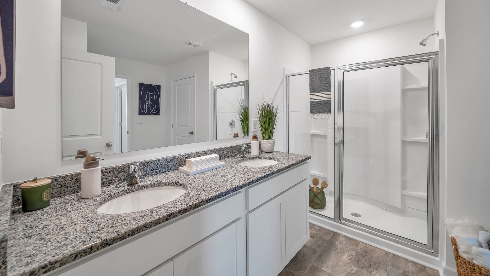 Primary bathroom with double vanity and walk-in shower