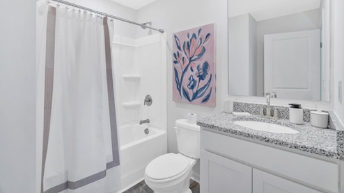 white bathroom with shower and double sinks