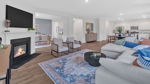 living room with fireplace and view of hallway