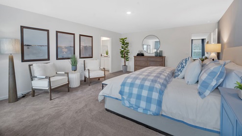 primary suite with white wall and one blue accent wall