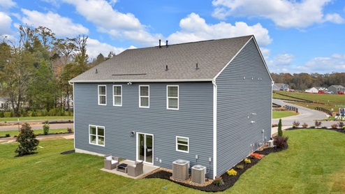 rear exterior of home with blue vinyl siding