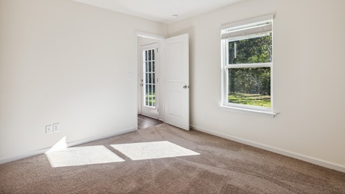 primary bedroom with carpet and white walls