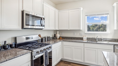 Kitchen countertop with stainless steel stove and microwave