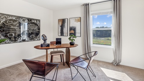 Bedroom with two accent chairs and desk