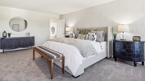 Primary bedroom with king bed and bench