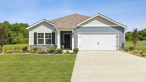 Exterior of one level home with blue vinyl siding, white shake, and a water table of gray stone