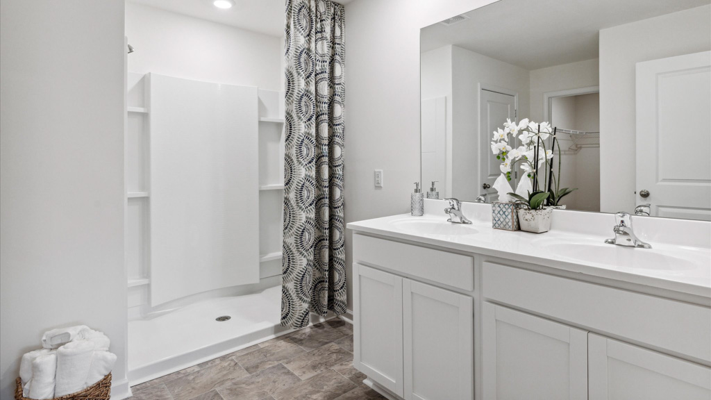 Primary bathroom with double vanity and walk-in shower