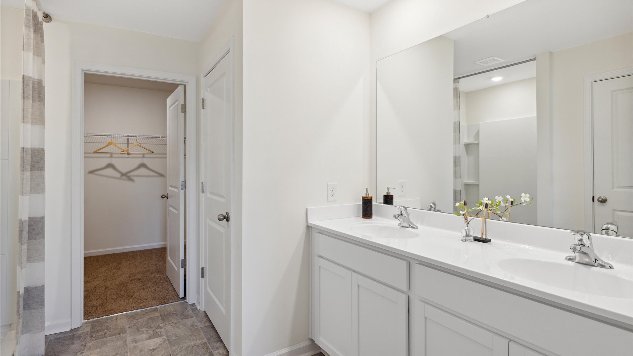 Primary bathroom with double vanity and walk-in shower